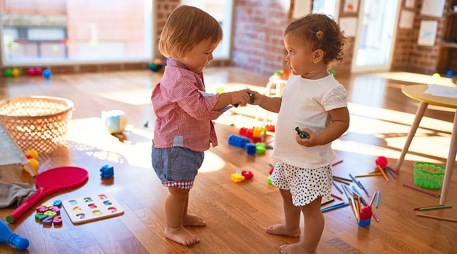 Zwei Kleinkinder, die miteinander spielen. 