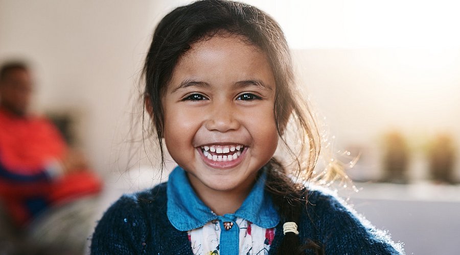 Brasilianisches Schulmädchen lacht in die Kamera.